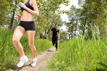 Image showing Healthy people jogging in forest