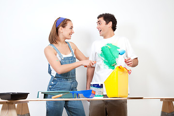 Image showing Happy woman having fun coloring her boyfriend's shirt