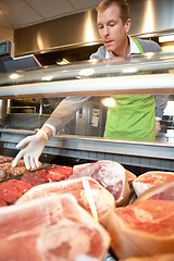 Image showing Market assistant picking meat