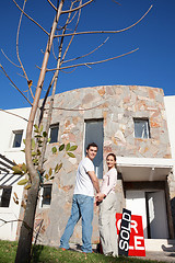 Image showing Happy couple in front of their new home