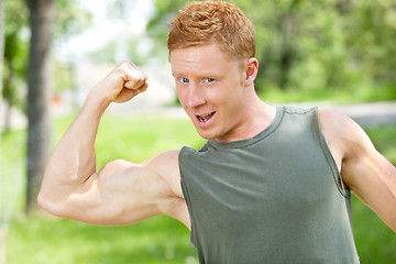 Image showing Muscular man showing his biceps