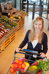 Image showing Portrait of woman holding shopping cart