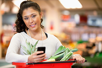 Image showing Woman with Shopping List on Phone