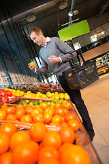 Image showing Man in Supermarket Buying Fruit