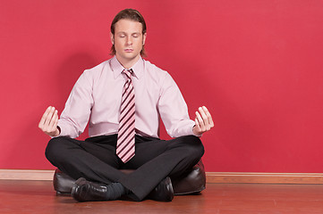 Image showing Businessman doing yoga exercise