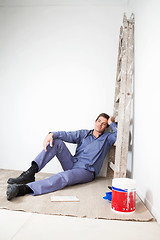 Image showing Thoughtful mature man sitting on floor