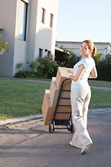 Image showing Pretty woman moving to a new house