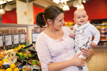 Image showing Happy mother carrying child