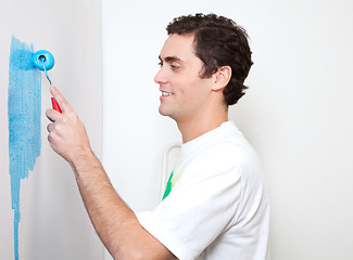Image showing Happy young man applying color