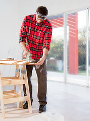 Image showing Man Sanding Boards