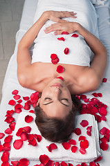 Image showing Beautiful relaxed woman lying on a massage table