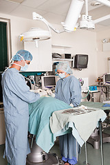 Image showing Two surgeons performing operation