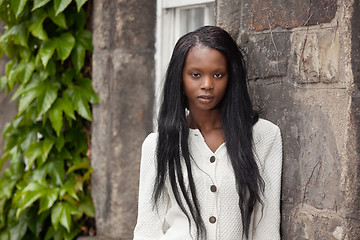 Image showing African American standing in front of stone wall