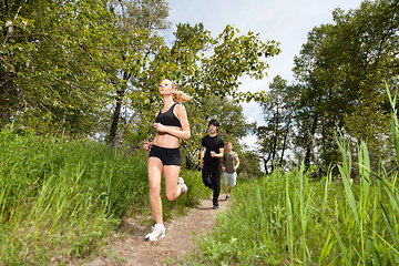 Image showing Three people running on pathway