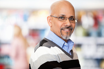 Image showing Mature man smiling while shopping