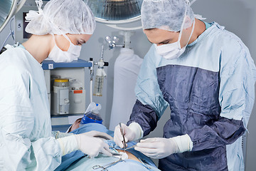 Image showing Medical professionals carrying on surgery on patient