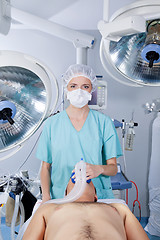 Image showing Doctor applying gas mask to a patient