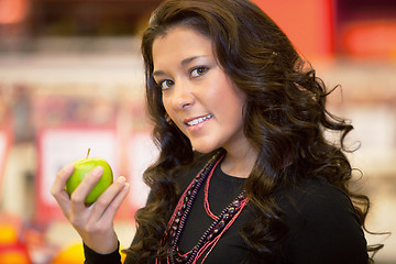 Image showing Closeup of a young woman holding apple