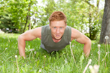 Image showing Portrait of man doing a push up