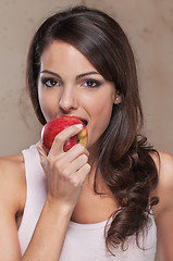 Image showing Beautiful young woman eating an apple