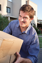 Image showing Portrait of smiling man holding box