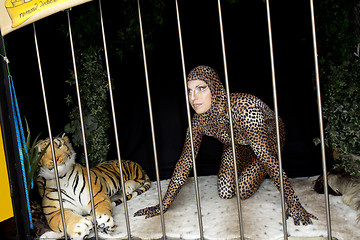 Image showing A woman locked in a cage with a tiger.