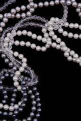 Image showing White and black pearls on the black silk