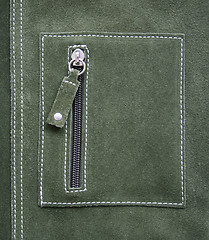 Image showing Pocket on green leather texture as background 