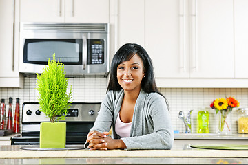 Image showing Young woman in kitchen