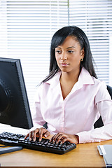 Image showing Serious black businesswoman at desk