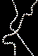 Image showing White pearls on the black silk 