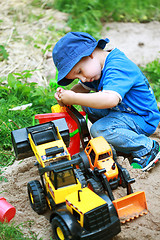 Image showing Boy playing with digger