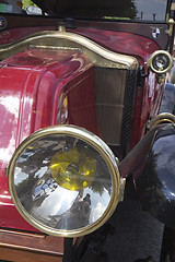 Image showing  Detail of a red classic car with headlight