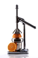 Image showing Chrome Citrus Juicer and Orange Halves