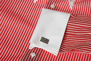 Image showing cuff link on men's red shirt 