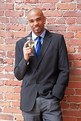 Image showing Young business man with a glass of wine