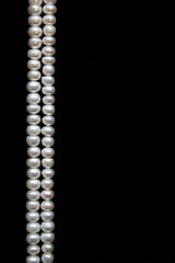 Image showing White pearls on the black background