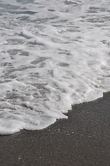 Image showing Foam on sand