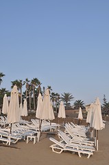 Image showing Beach chairs and umbrellas