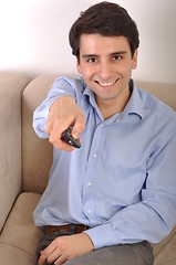 Image showing Smiling man watching tv