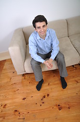 Image showing Man sitting on the couch