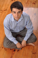 Image showing Man sitting on the floor