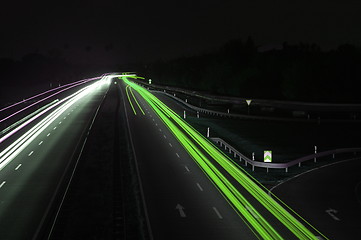 Image showing road with car traffic at night with blurry lights