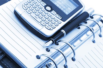 Image showing note book and phone