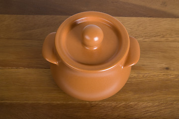 Image showing Clay pot on the wooden board