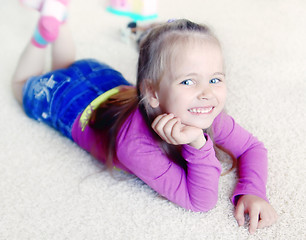 Image showing Little girl on a carpet