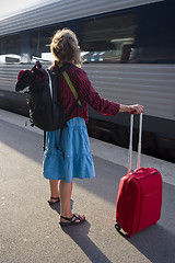 Image showing Woman with roller bag