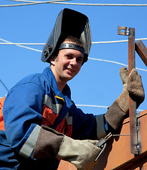 Image showing A welder working at height