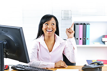 Image showing Businesswoman having idea at desk