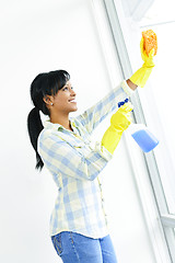 Image showing Smiling woman cleaning windows